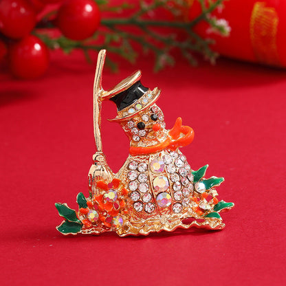 Orange Enamel and Cubic Zirconia Broom Snowman Brooch, brooch pin, vintage-inspired design, front view