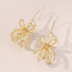 Stunning 18K gold-plated drop earrings showcasing a large, abstract flower design, perfect for any occasion.