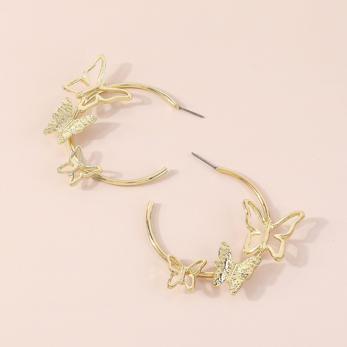 Chic butterfly hoop earrings in gold tone, featuring 18K gold plating for a sophisticated and trendy accessory.