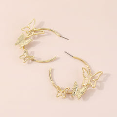 Chic butterfly hoop earrings in gold tone, featuring 18K gold plating for a sophisticated and trendy accessory.