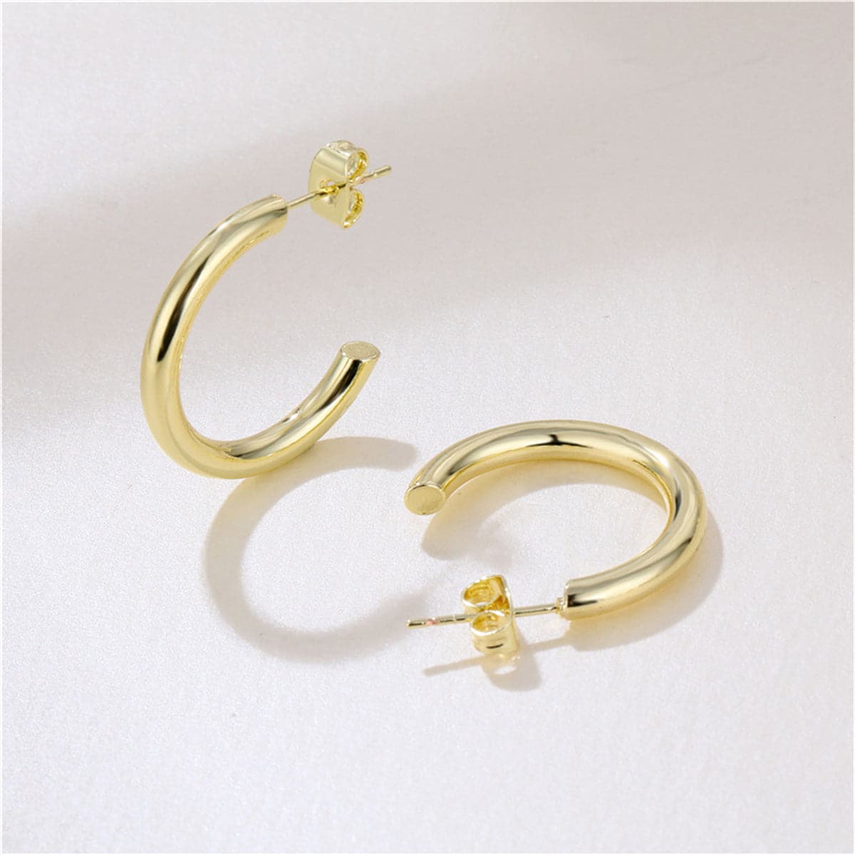 Elegant 18K gold-plated C-shape huggie earrings, showcasing a stunning gold hoop design for a chic look.