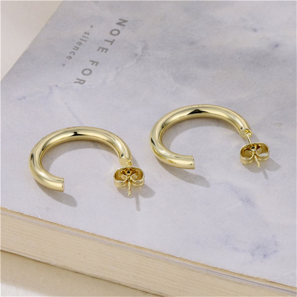Dazzling 18K gold-plated C-shape huggie earrings, offering a luxurious gold hoop style for everyday elegance.