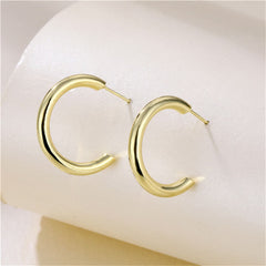 Stylish 18K gold-plated C-shape huggie earrings, featuring a classic gold hoop design for a timeless accessory.
