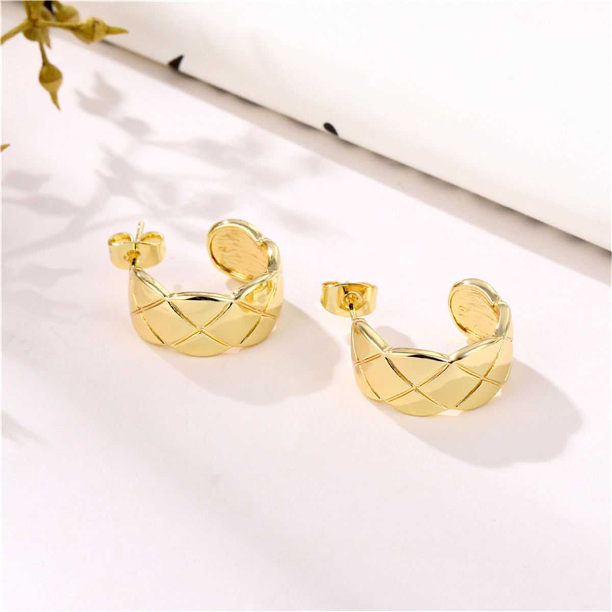 Stunning gold-plated hoop earrings with a unique C-shape quilt design, adding a touch of elegance to your style.