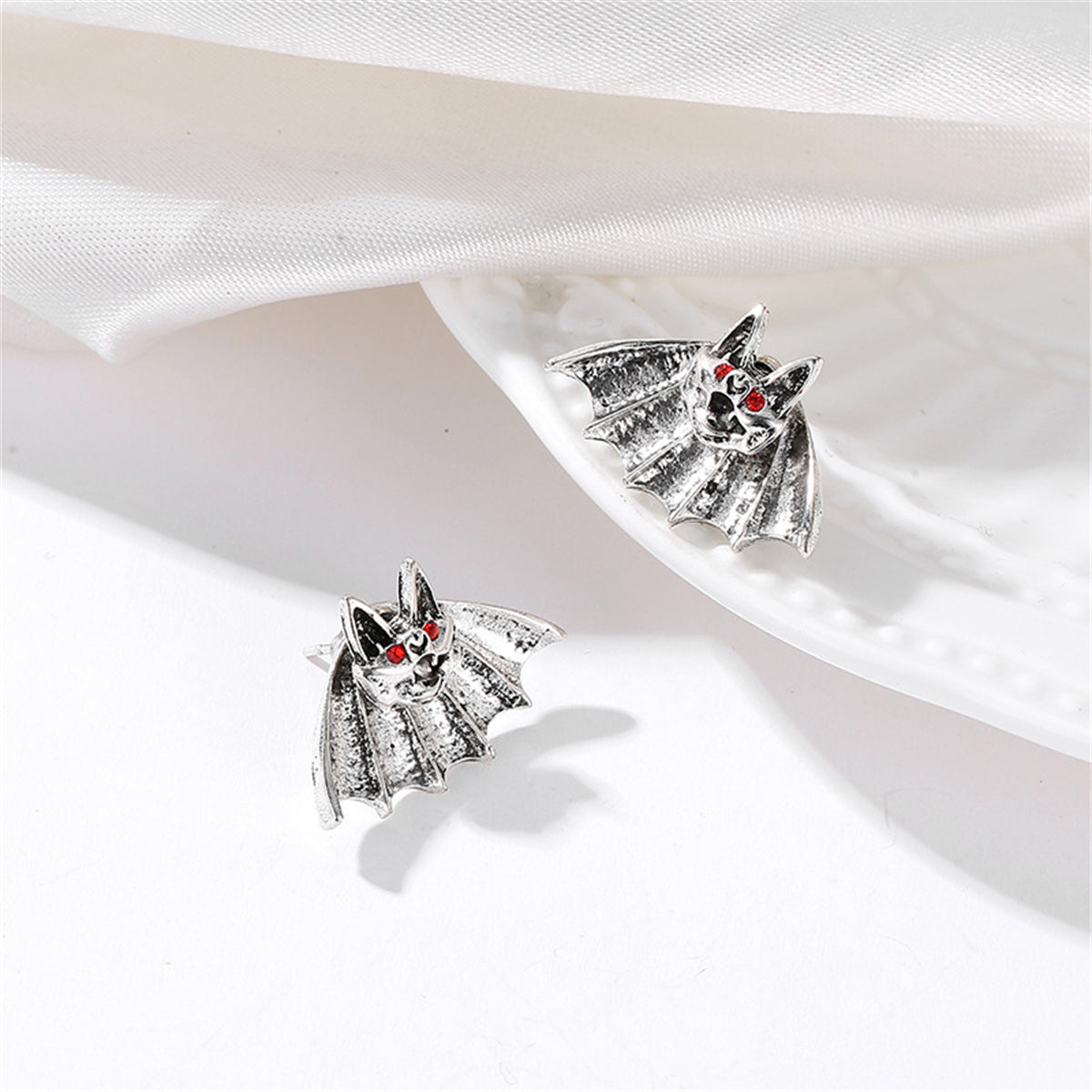 Red Cubic Zirconia and Silver-Plated Bat Stud Earrings, silver stud earrings for women, detail close-up