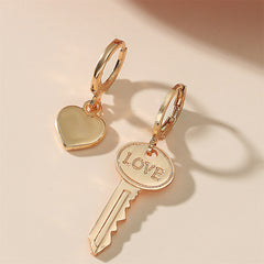 Chic 18K gold-plated earrings featuring heart and key charms, adorned with 'love' for a stylish expression of love.