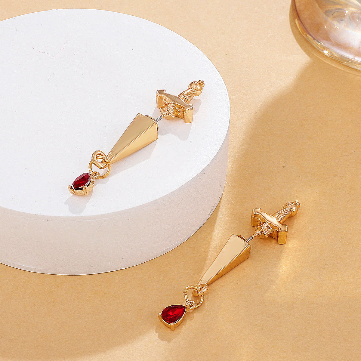 Red Crystal and 18K Gold-Plated Sword Ear Jackets, gold drop earrings for women, botanical inspired, detail close-up