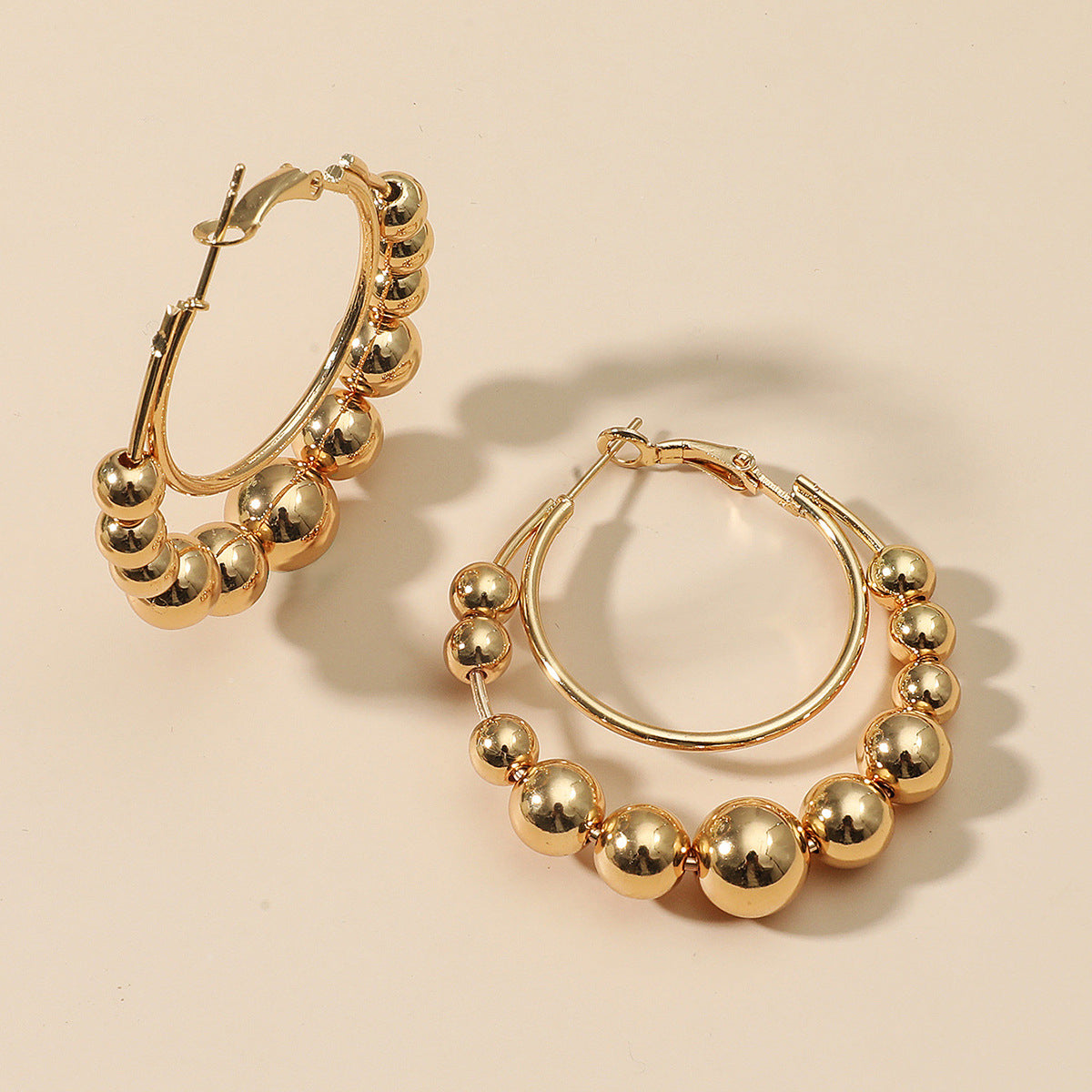 Beautifully crafted 18K gold-plated hoop earrings with beads, designed to make a statement and complement your style.