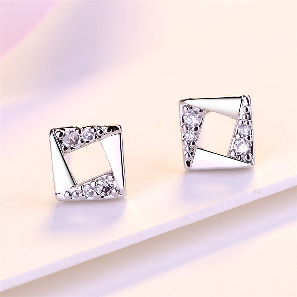 Cubic Zirconia and Silver-Plated Asymmetrical Rhombus Stud Earrings, silver stud earrings for women, detail close-up