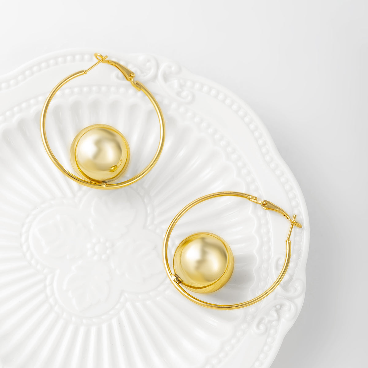 Beautiful 18K gold-plated hoop earrings adorned with a sleek ball at the end, ideal for elevating your jewelry collection.