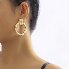 Elegant 18K gold-plated bamboo-shaped round drop earrings featuring a stunning circular design.