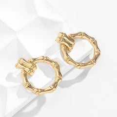 Stunning 18K gold-plated bamboo-shaped round drop earrings showcasing a unique circular design for any occasion.