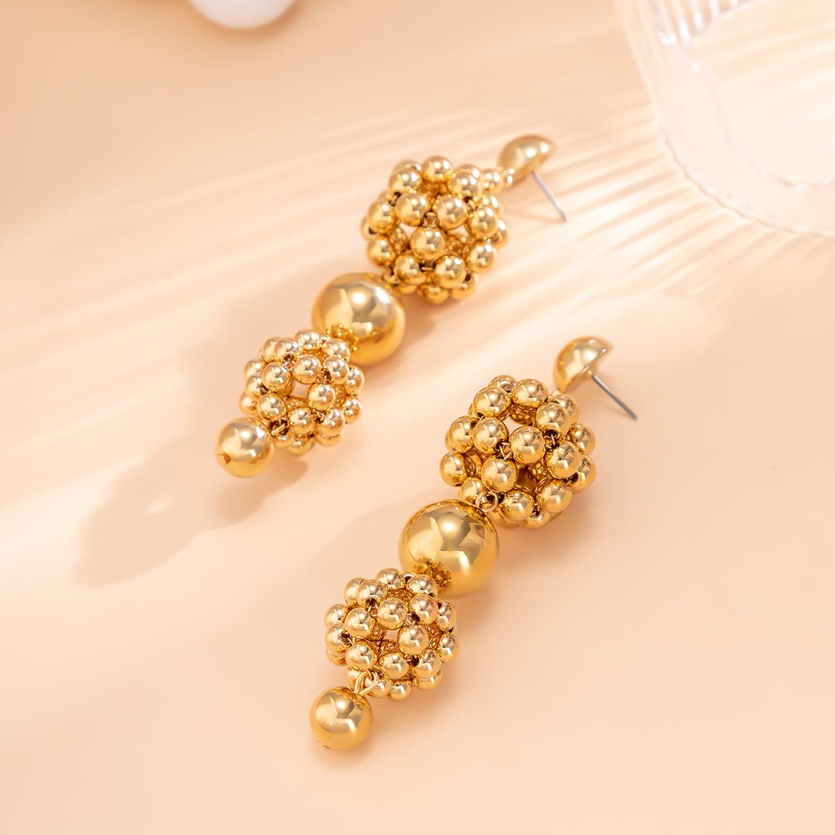 Dazzling 18K gold-plated bead cluster drop earrings with intricate balls and beads, a must-have accessory for fashion lovers.