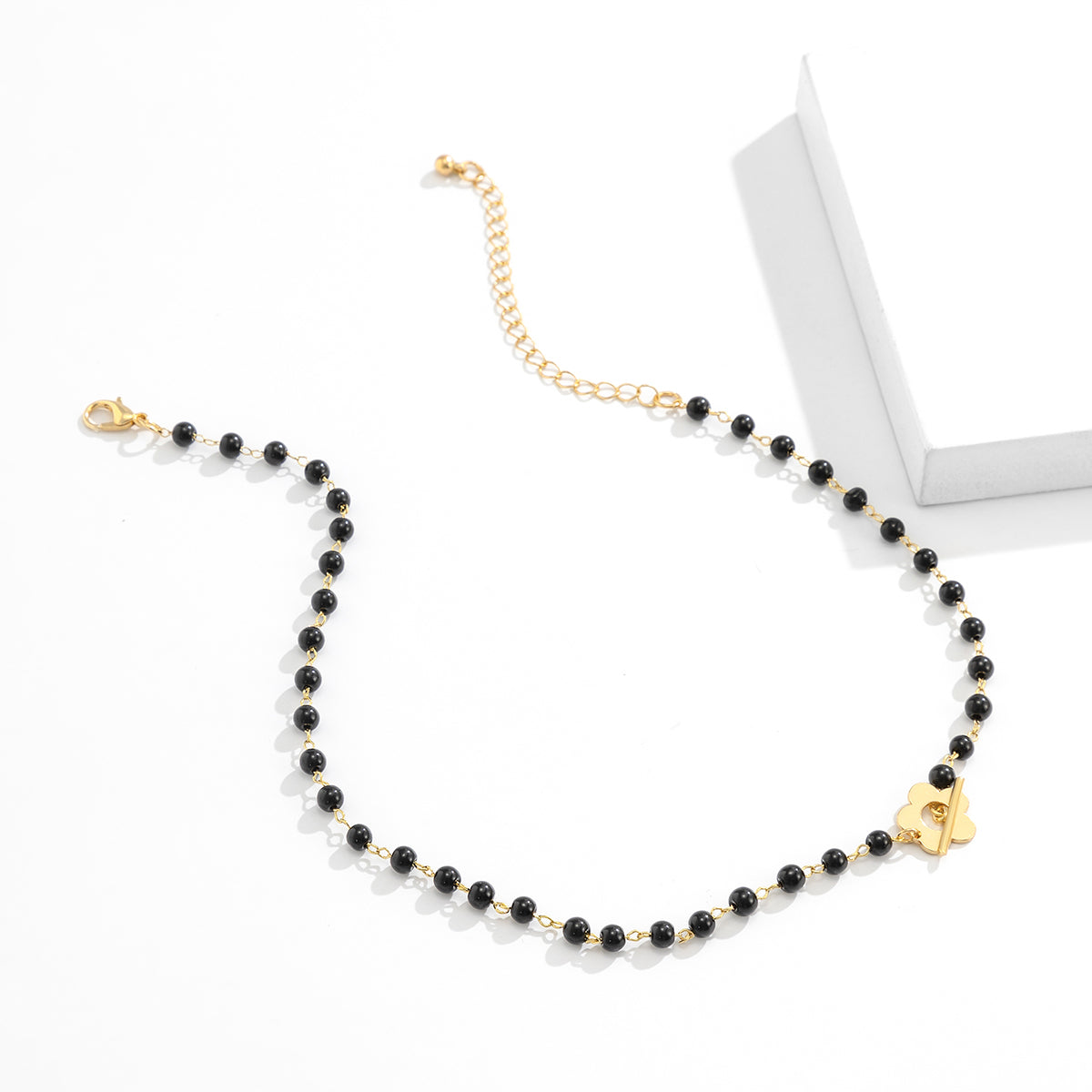Black and 18K Gold-Plated Flower Choker Necklace, gold pendant necklace for women, botanical inspired, detail close-up