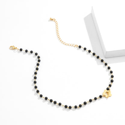 Black and 18K Gold-Plated Flower Choker Necklace, gold pendant necklace for women, botanical inspired, detail close-up
