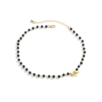 Black and 18K Gold-Plated Flower Choker Necklace, gold pendant necklace for women, botanical inspired, side view