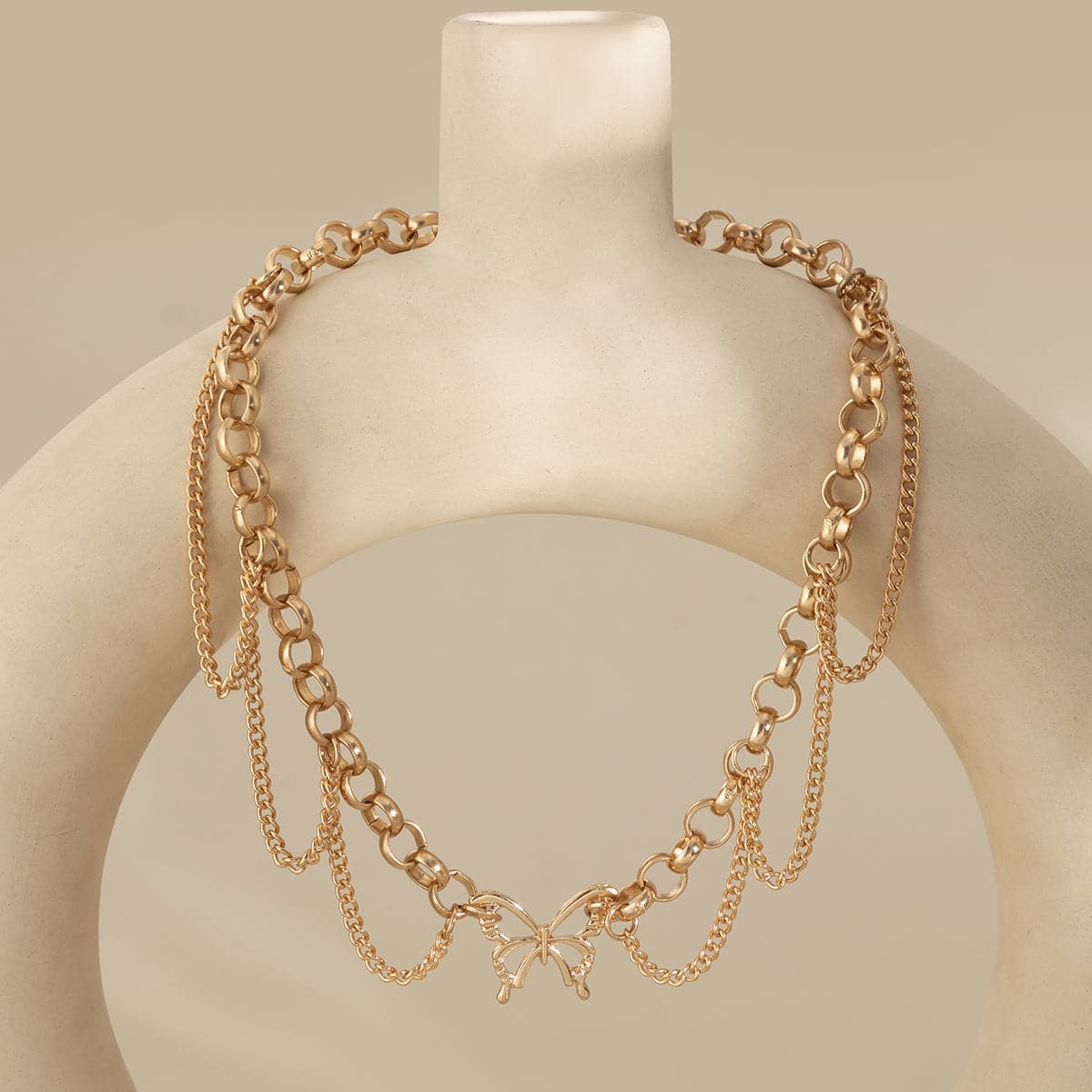 Chic 18K gold-plated choker necklace with a butterfly charm and tassels, a must-have accessory for a fashionable look.