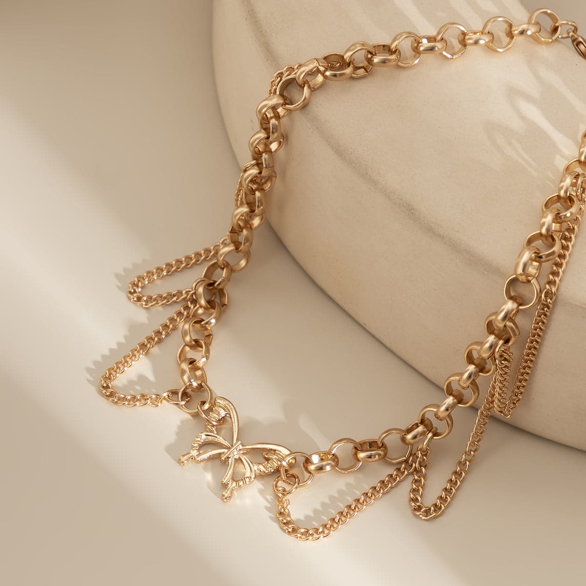 Beautiful 18K gold-plated choker adorned with a butterfly charm and tassels, ideal for elevating your outfit effortlessly.
