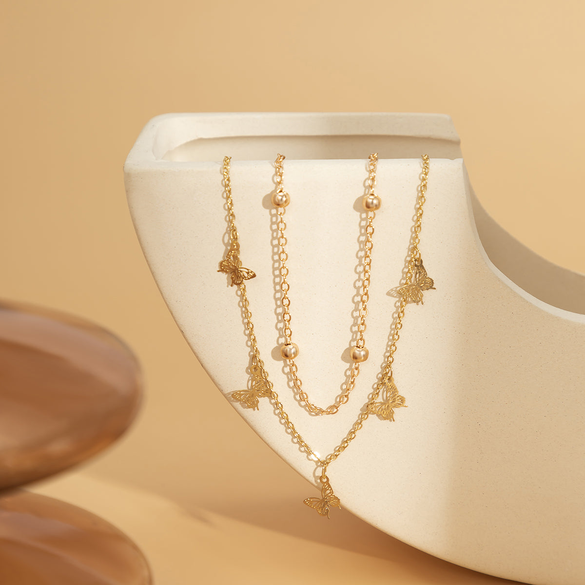 Exquisite 18K gold-plated charm anklet showcasing butterfly designs, perfect for adding charm and elegance to your style.