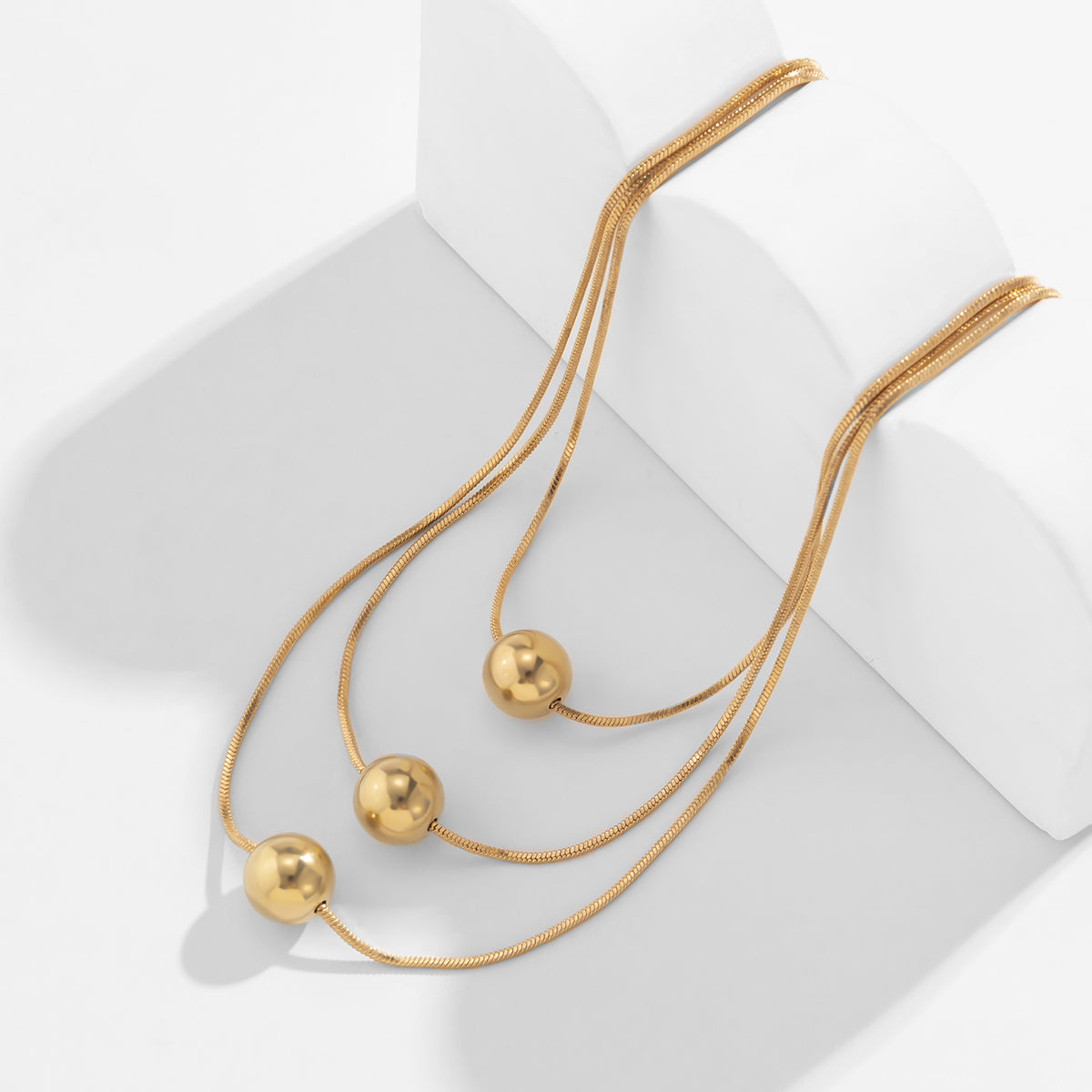 Chic 18K gold-plated necklace set with three strands and a radiant golden ball, ideal for elevating your style.
