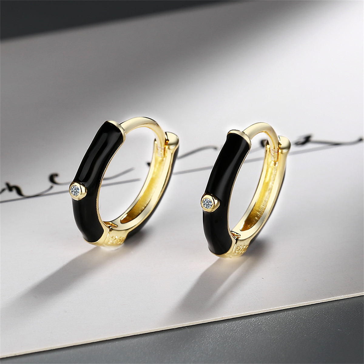 Black Enamel and Cubic Zirconia 18K Gold-Plated Huggie Earrings, gold huggie earrings, botanical inspired, side view
