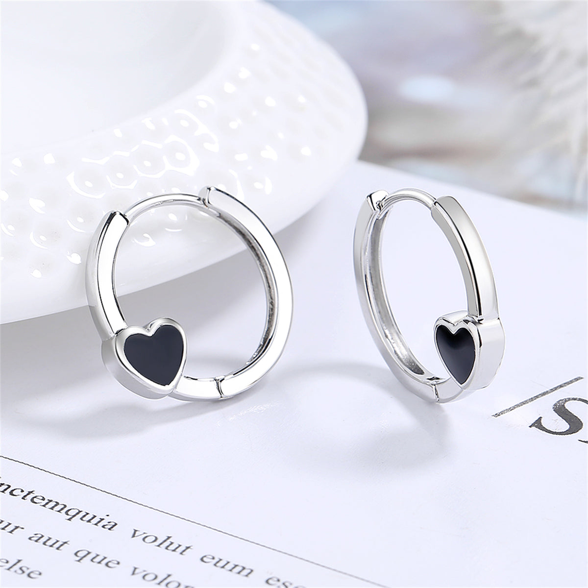 Black Enamel and Silver-Plated Heart Huggie Earrings, silver huggie earrings, botanical inspired, side view