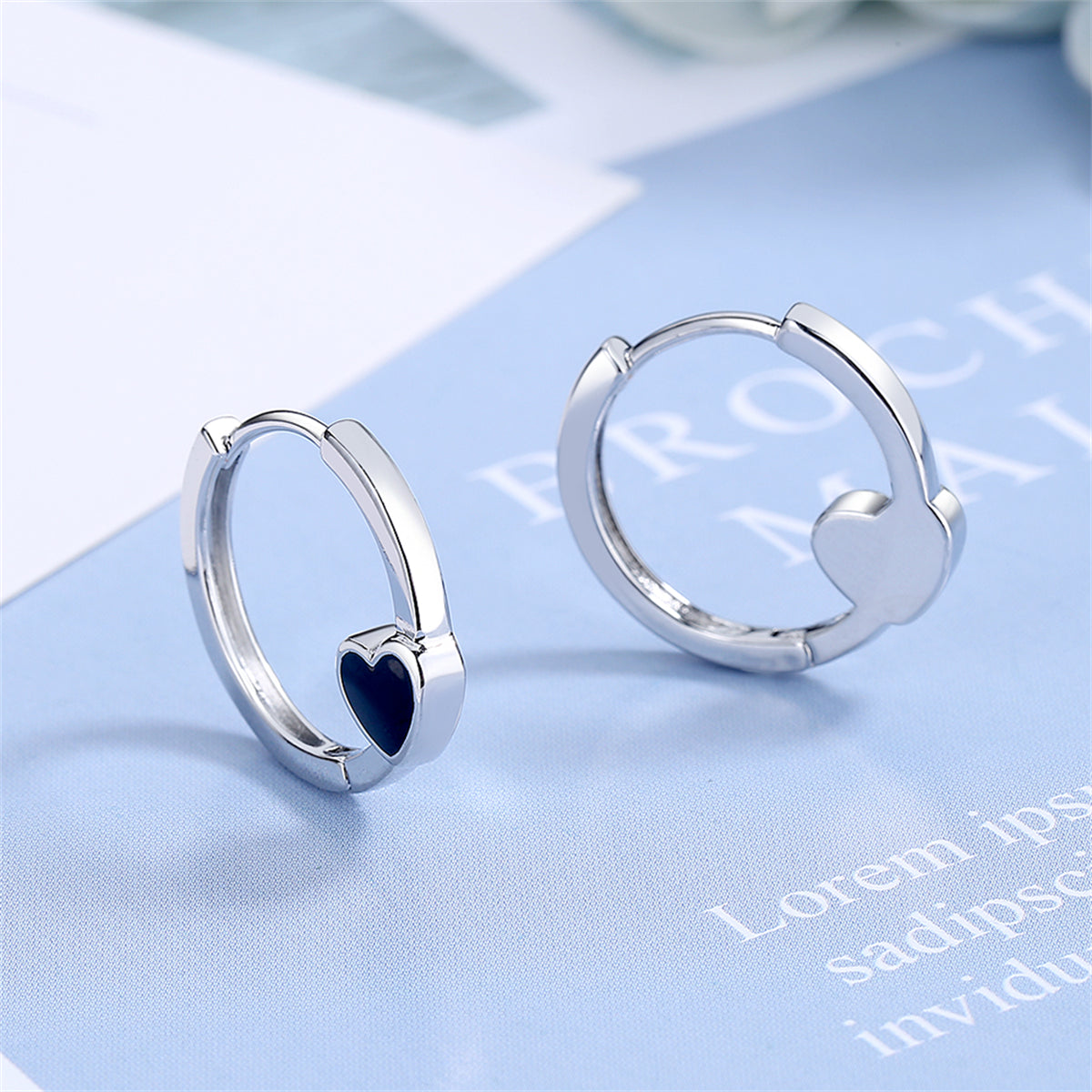 Black Enamel and Silver-Plated Heart Huggie Earrings, silver huggie earrings, botanical inspired, front view