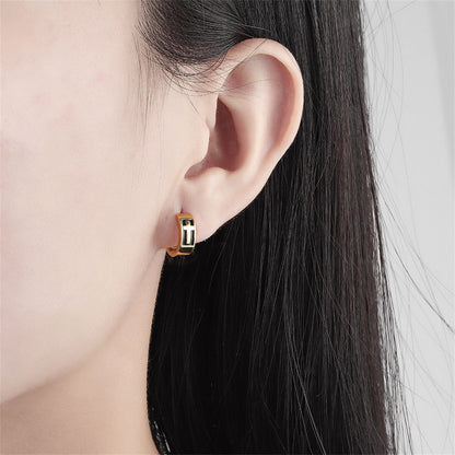 Black Enamel and 18K Gold-Plated Cross Huggie Earrings, gold huggie earrings, everyday style, detail close-up