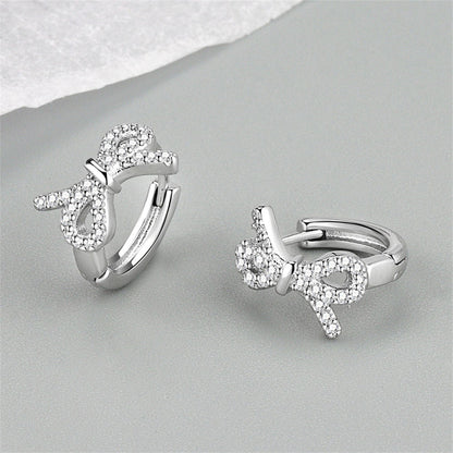 Clear Cubic Zirconia and Silver-Plated Bow Huggie Earrings, silver huggie earrings, everyday style, side view