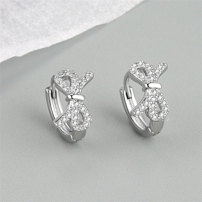 Clear Cubic Zirconia and Silver-Plated Bow Huggie Earrings, silver huggie earrings, everyday style, detail close-up