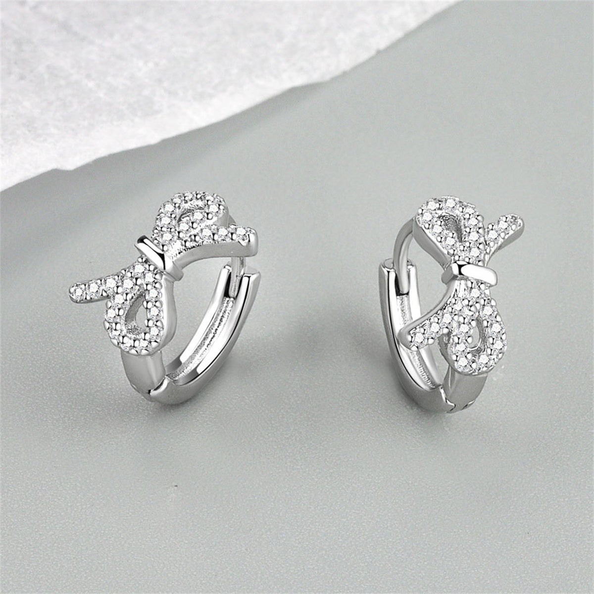 Clear Cubic Zirconia and Silver-Plated Bow Huggie Earrings, silver huggie earrings, everyday style, lifestyle look