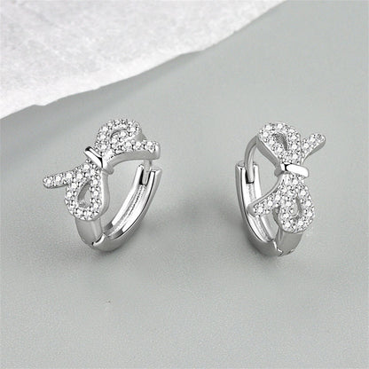 Clear Cubic Zirconia and Silver-Plated Bow Huggie Earrings, silver huggie earrings, everyday style, lifestyle look