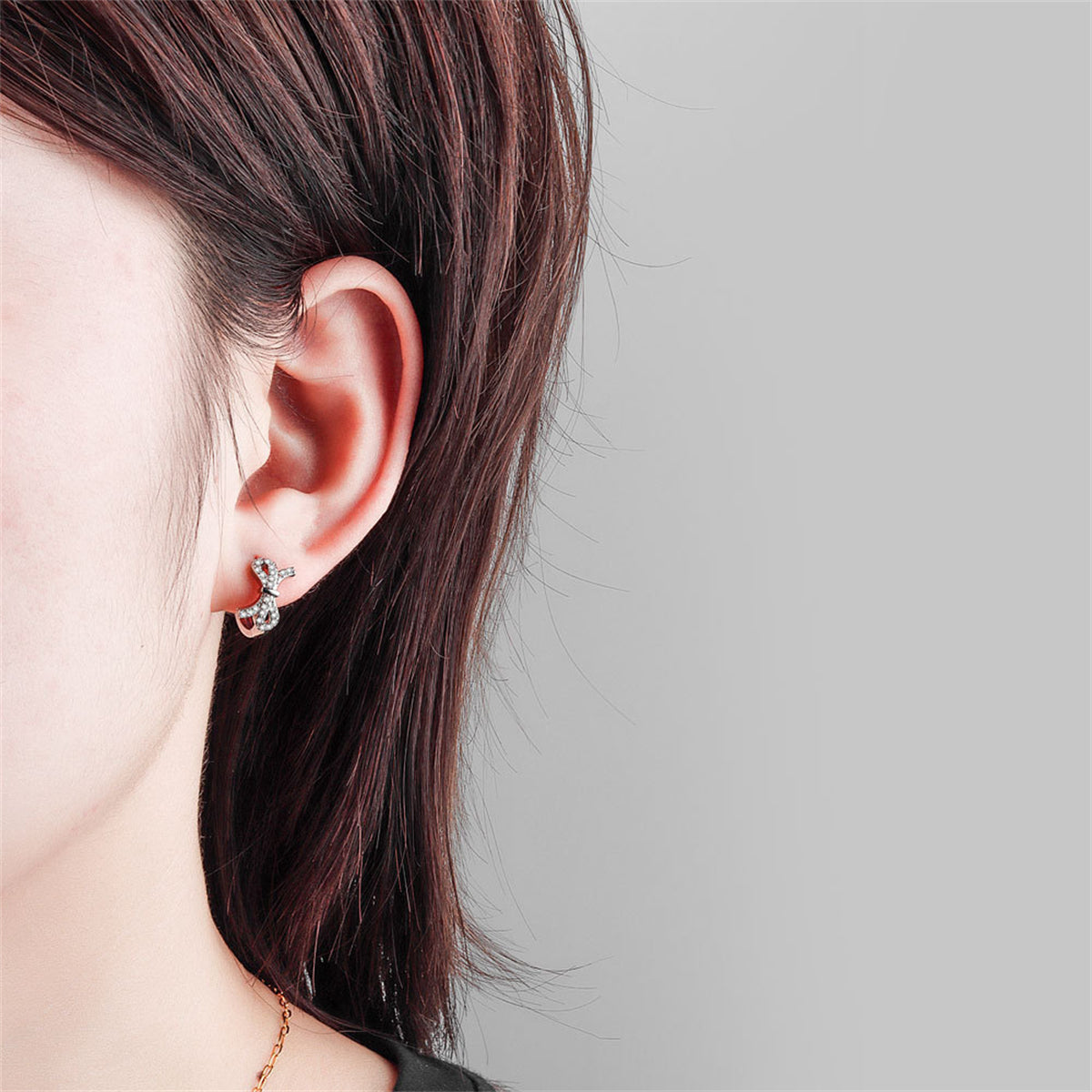 Clear Cubic Zirconia and Silver-Plated Bow Huggie Earrings, silver huggie earrings, everyday style, styled look