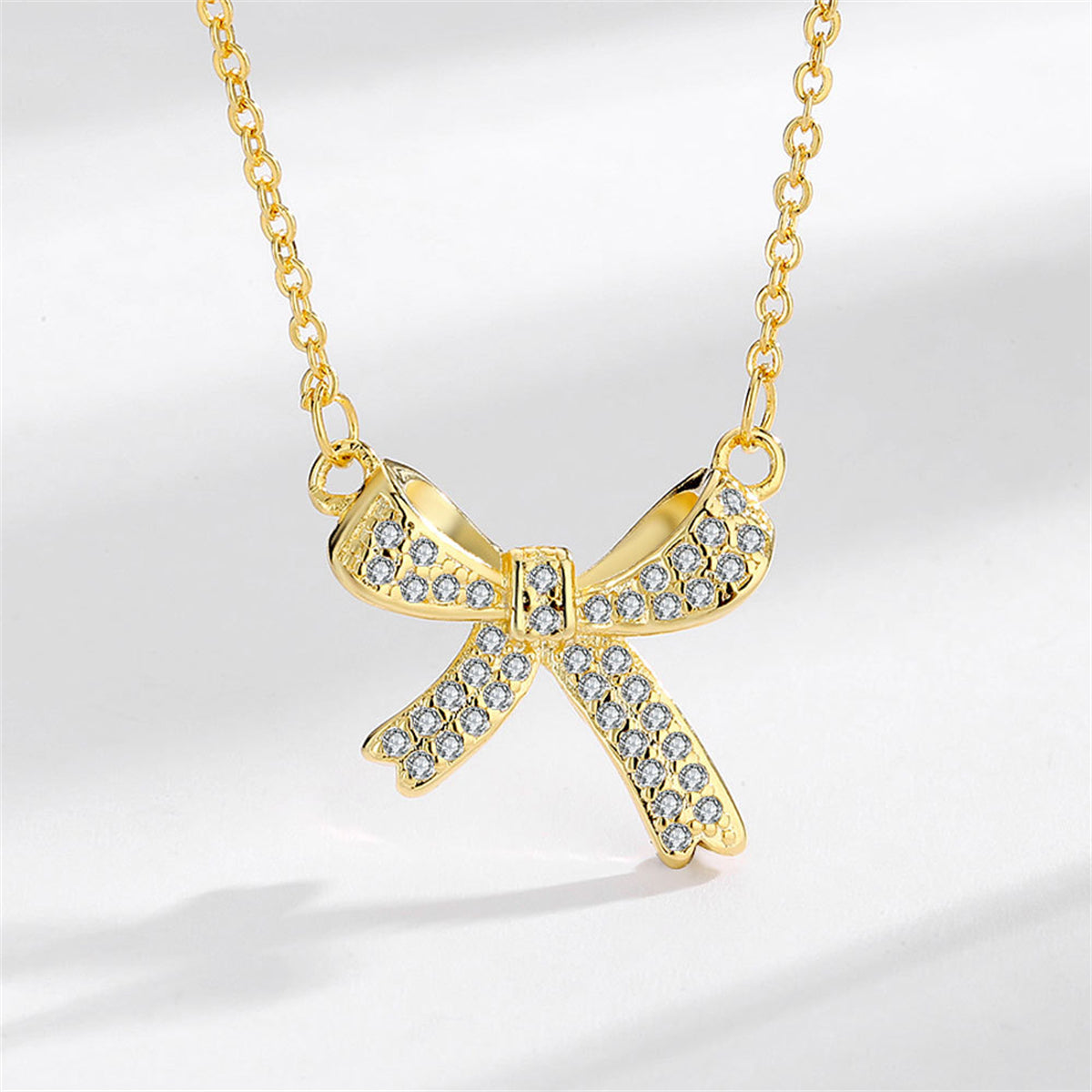 Cubic Zirconia and 18K Gold-Plated Bow Pendant Necklace, gold pendant necklace for women, vintage-inspired design, front view