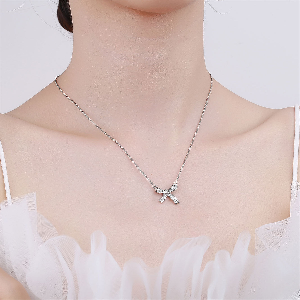 Cubic Zirconia and Silver-Plated Bow Pendant Necklace, silver pendant necklace for women, dainty minimalist design, side view