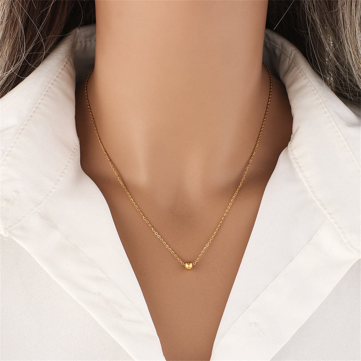 Stunning 18K gold-plated bead pendant necklace elegantly hanging on a chain, perfect for adding a touch of glamour.