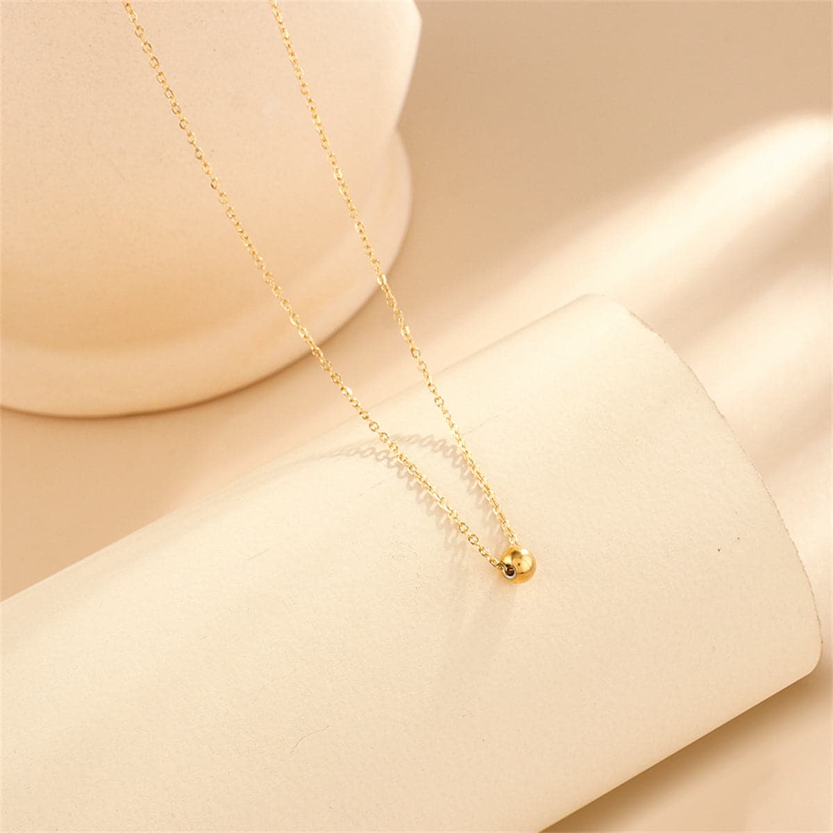 Beautiful 18K gold-plated bead pendant necklace featured on a chain, radiating sophistication and timeless style.