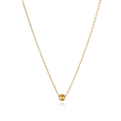 Elegant 18K gold-plated bead pendant necklace displayed on a delicate chain, showcasing its luxurious design and shine.