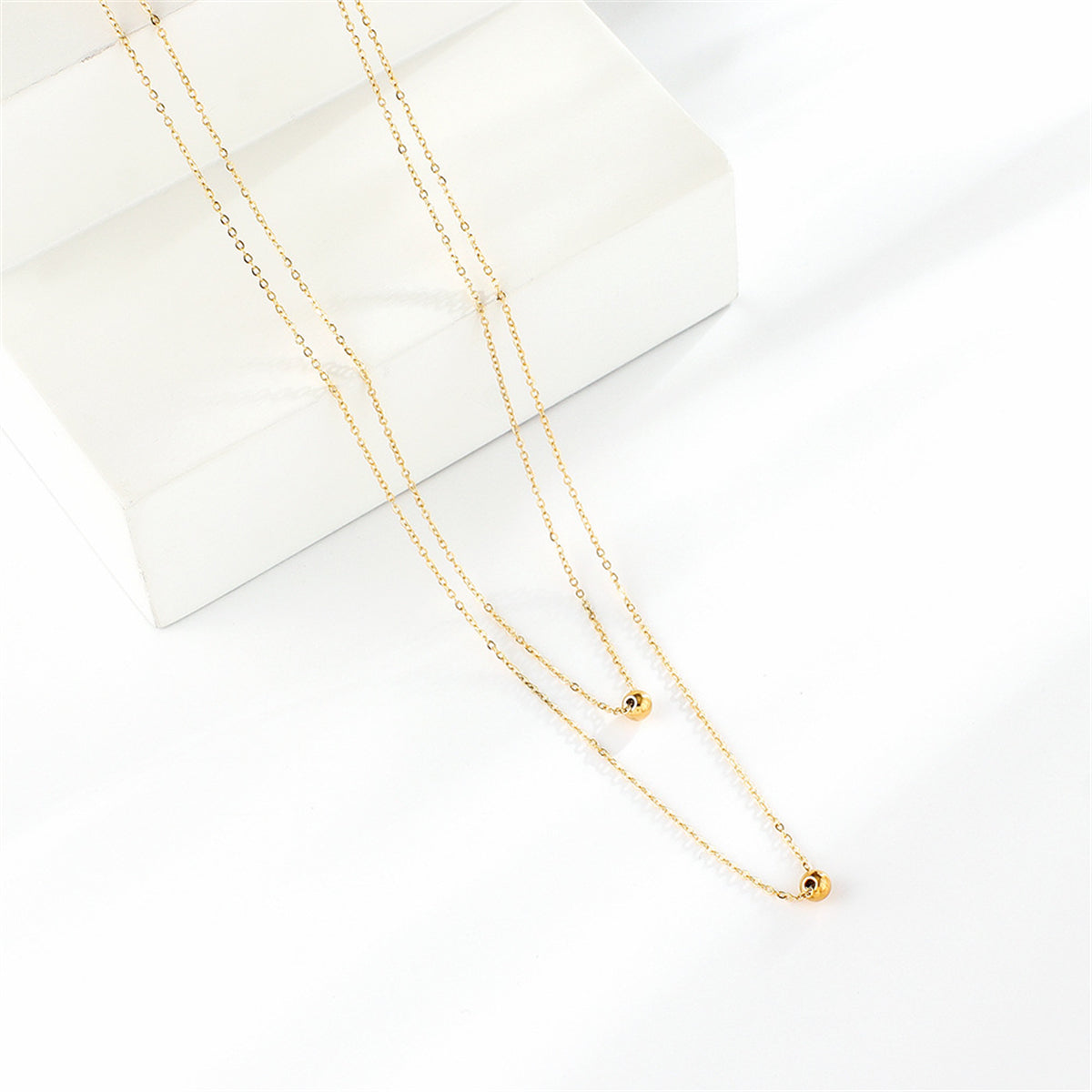 18K gold-plated layered necklace with two striking gold balls, ideal for enhancing your style with a touch of luxury.