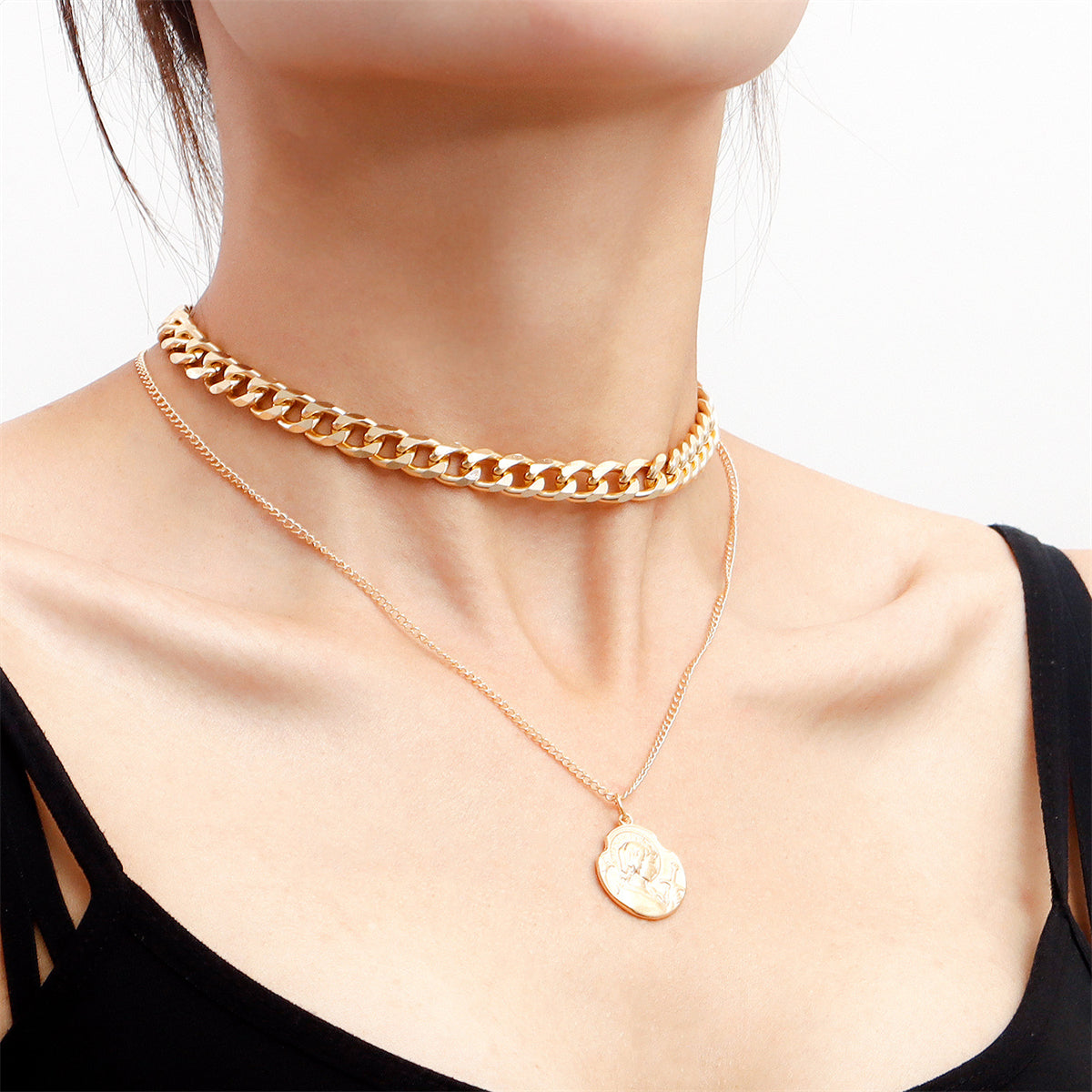 Stunning 18K gold-plated curb chain necklace adorned with a unique coin charm, perfect for layering and elevating any outfit.