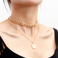 Stunning 18K gold-plated curb chain necklace adorned with a unique coin charm, perfect for layering and elevating any outfit.
