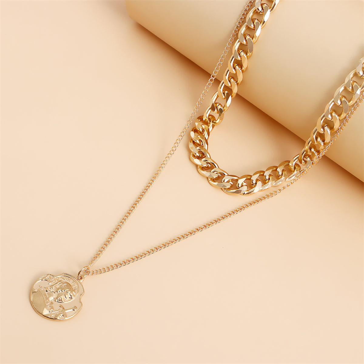 Fashionable 18K gold-plated curb chain necklace with a coin charm, designed to elevate your style with a layered effect.