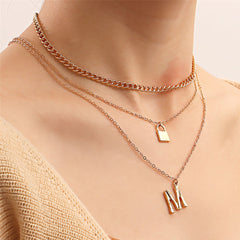 Stunning 18K gold-plated layered necklace with a chic 'M' lock pendant and a key, adding a touch of luxury to your style.