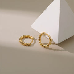 Stunning 18k gold ball hoop earrings that elevate your style with their timeless elegance and shine.