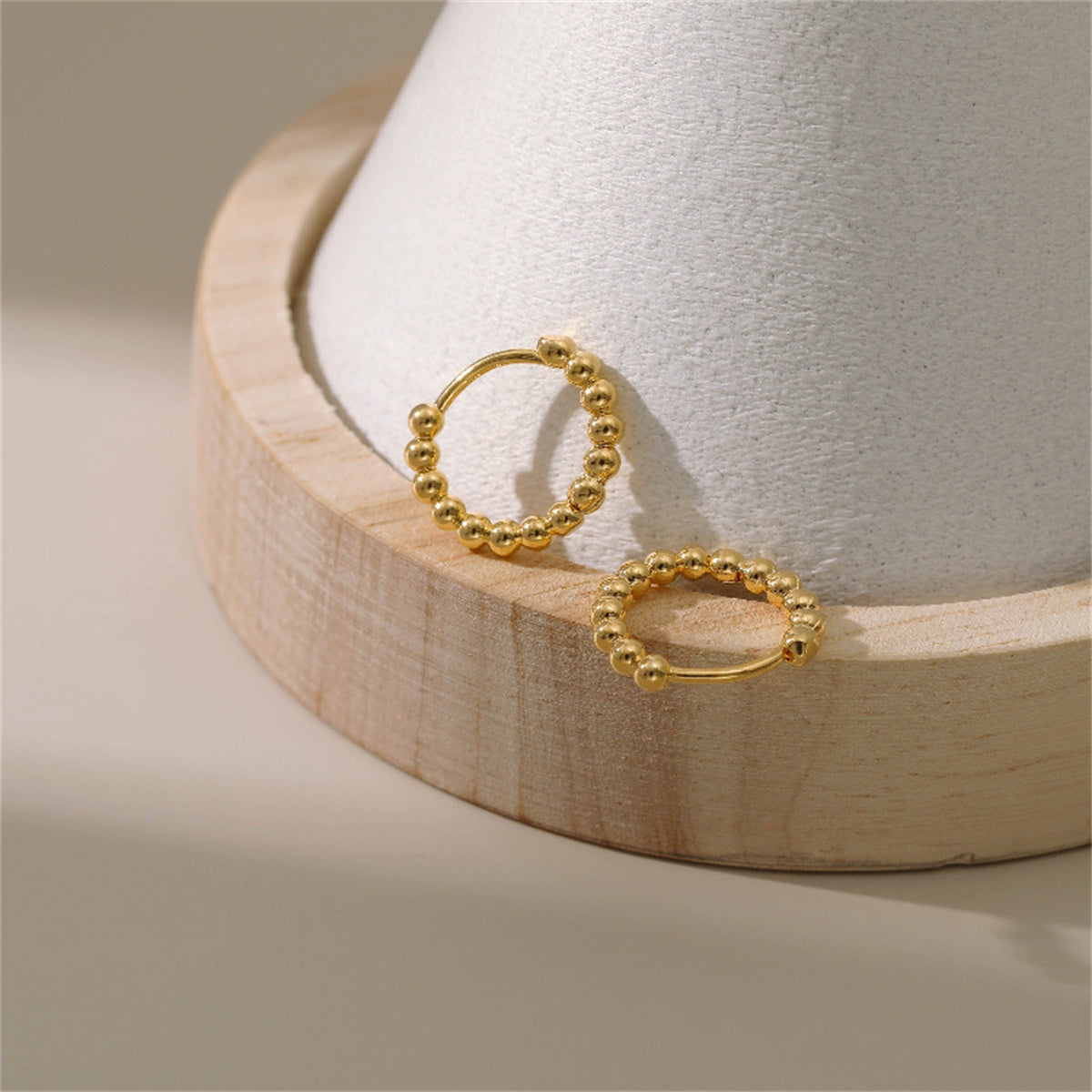 Beautiful 18k gold ball hoop earrings, designed to enhance your jewelry collection with their classic appeal.