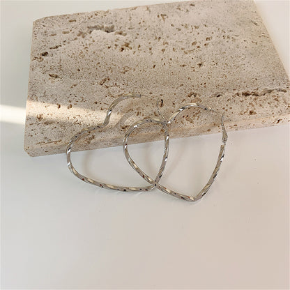 Silver-Plated Twisted Heart Hoop Earrings, botanical inspired, detail close-up