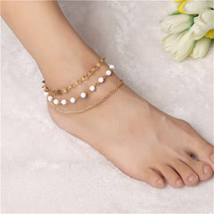 Elegant 18K gold-plated anklet featuring a gold chain adorned with beautiful white beads for a chic look.